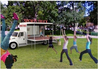 A yoga instructor teaching yoga from the Sports truck-stage.