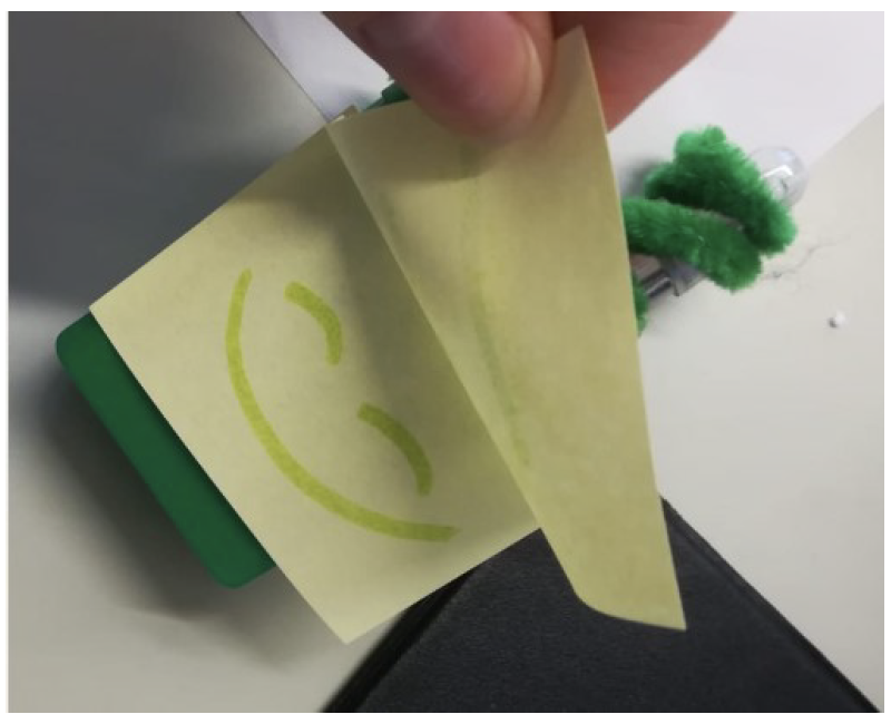 A rapidly made prototype of an interactive waste bin that shows a smily face when you use it.